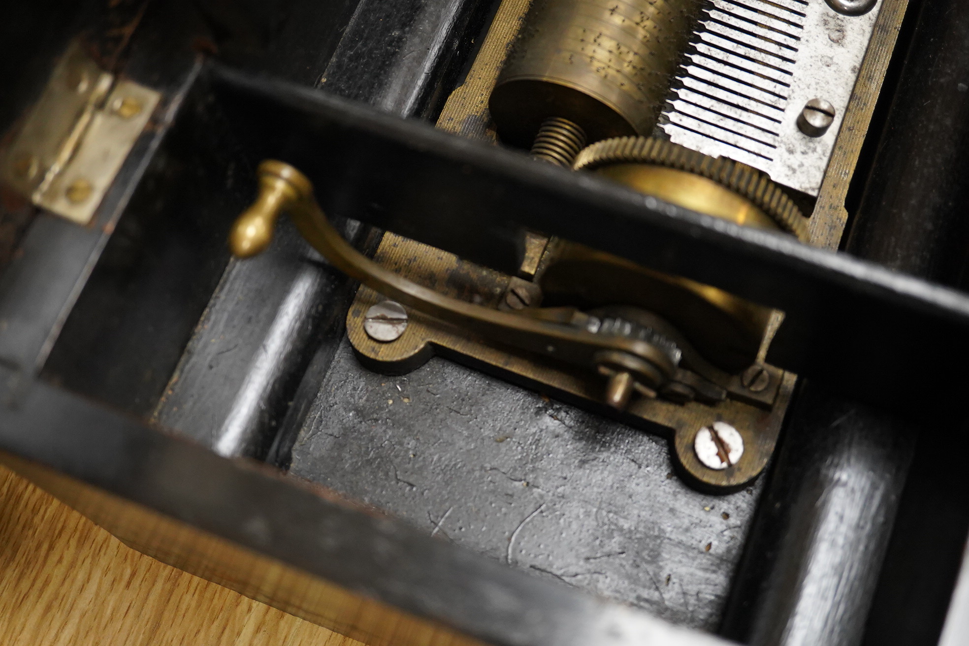 A mid-19th century inlaid and ebonised rosewood Swiss cylinder music box playing eight airs, card label to the inside of the lid listing the airs, complete with all teeth to the comb, cylinder 15.3cm long, the case; 43cm